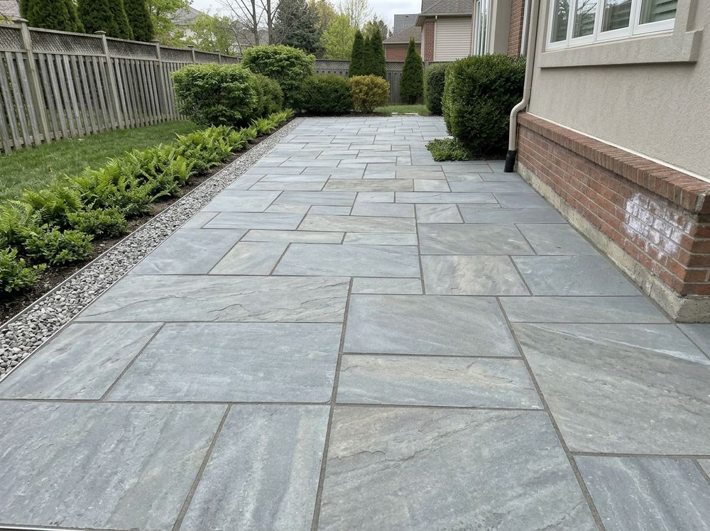 Large paver or flagstone patio with clean joints and a disciplined edge