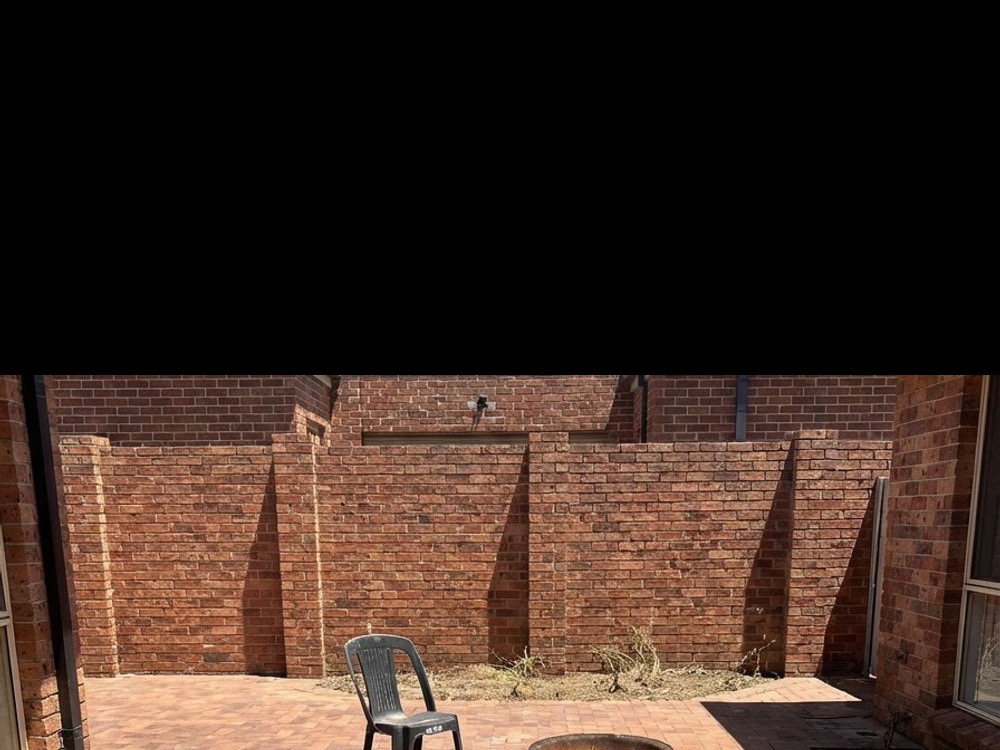 Enclosed brick courtyard before landscaping
